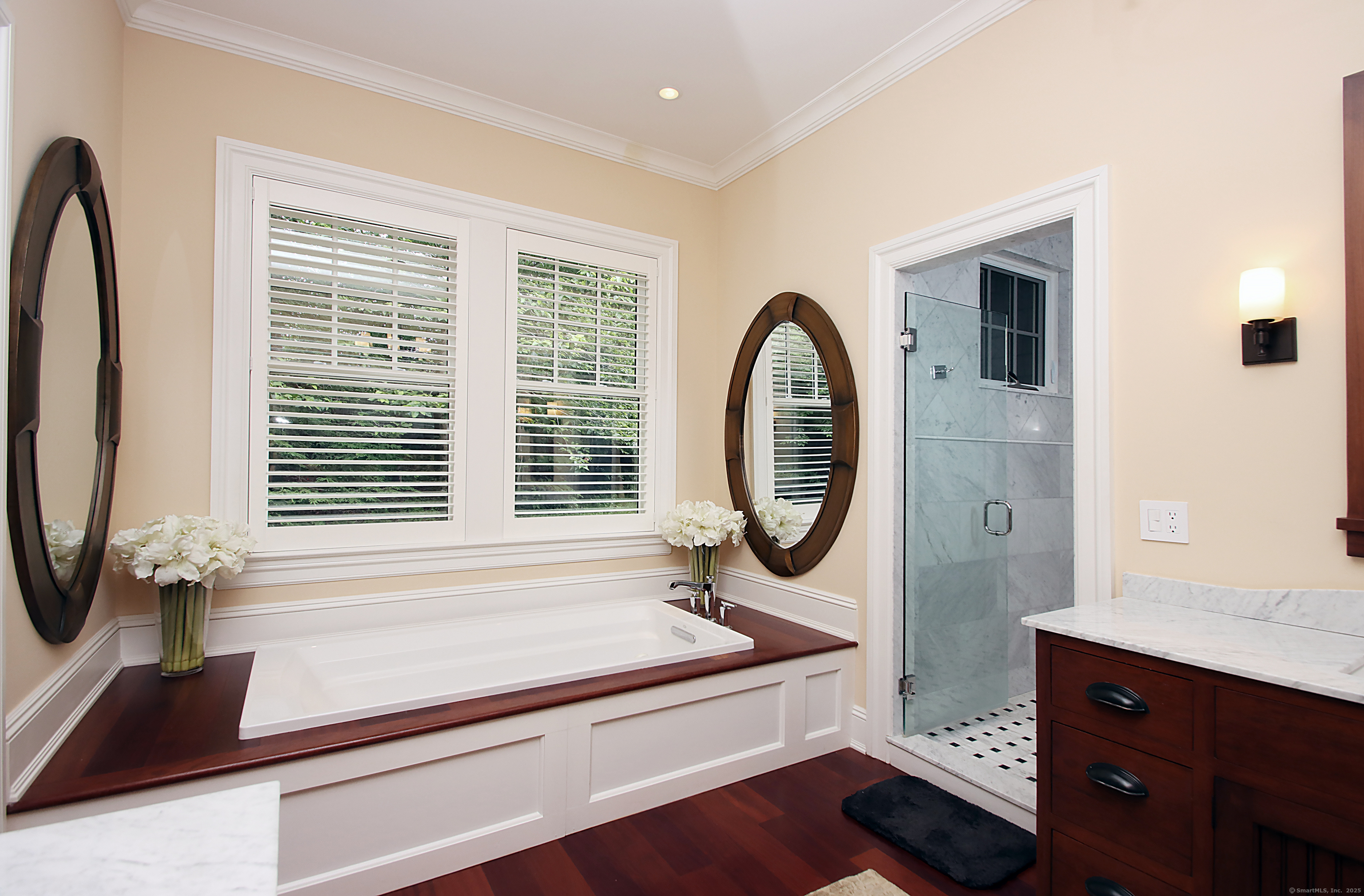 25 Sky View Drive Avon, CT 06001 - Photo 23 of 40 a bathroom with a sink a mirror and a window