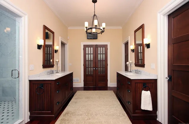 a bathroom with a double vanity sink and a mirror