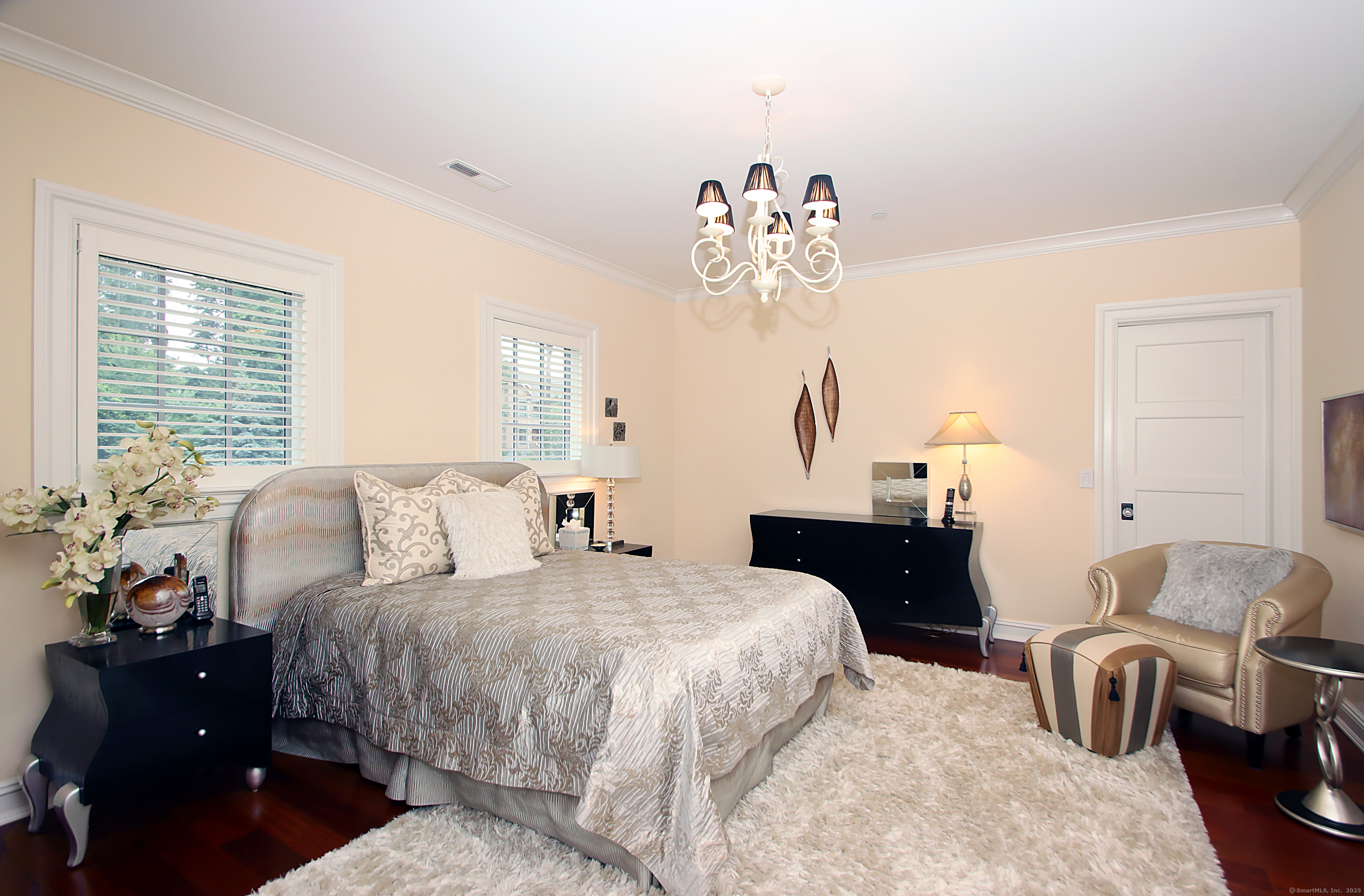 25 Sky View Drive Avon, CT 06001 - Photo 28 of 40 a bedroom with a bed and a chandelier