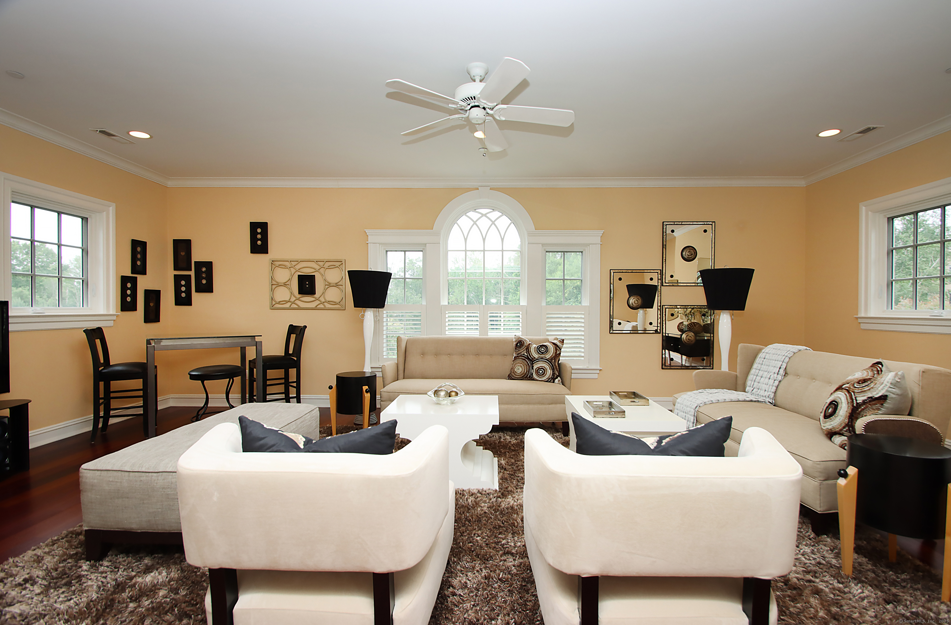 25 Sky View Drive Avon, CT 06001 - Photo 30 of 40 a living room with furniture a fireplace and a chandelier