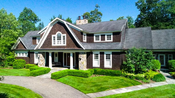 a front view of a house with a yard