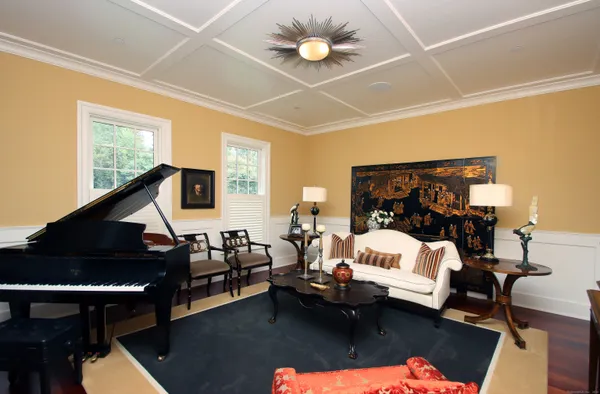 a living room with furniture and a chandelier