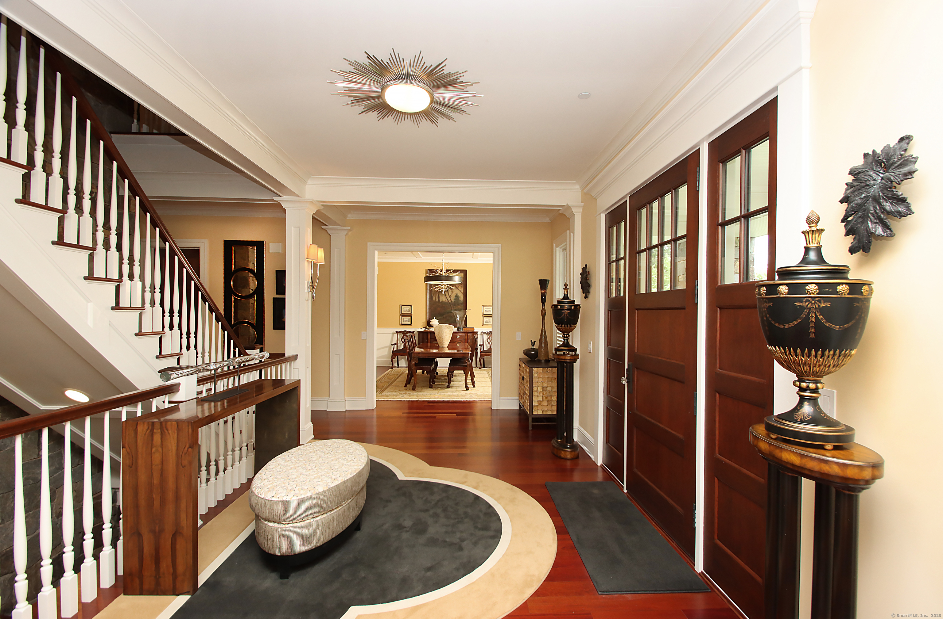 25 Sky View Drive Avon, CT 06001 - Photo 6 of 40 a view of a hallway to a livingroom with wooden floor and furniture