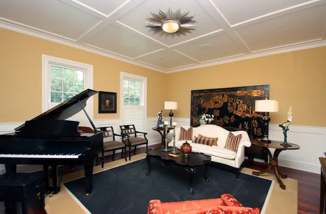 a living room with furniture and a chandelier