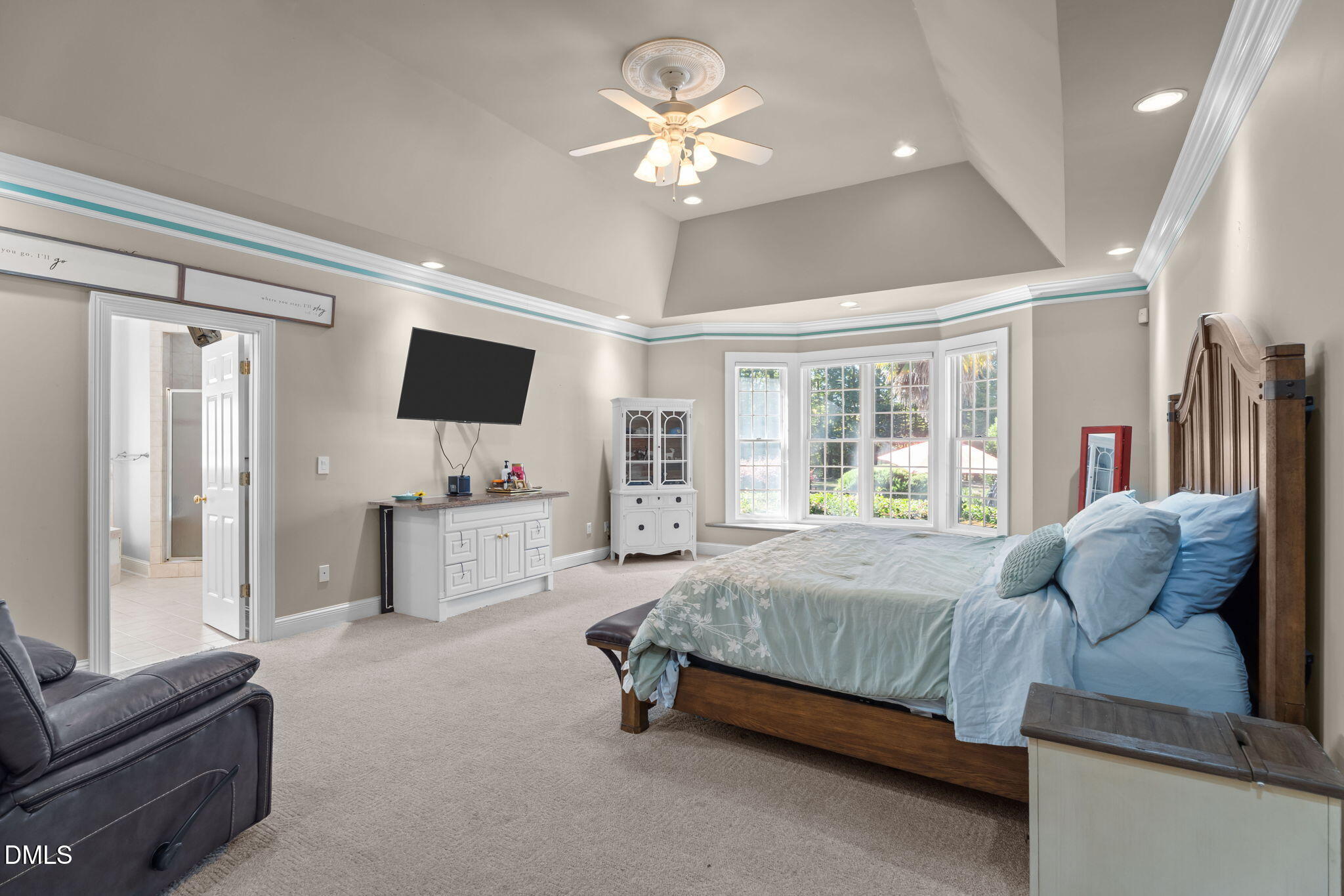 5870 Hoyt Road Middlesex, NC 27557 - Photo 15 of 33 a bedroom with a bed a flat screen tv and couches