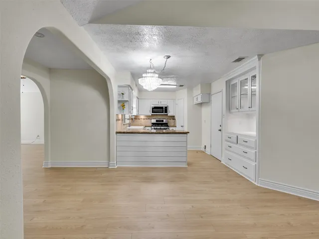 a kitchen with stainless steel appliances granite countertop a sink and cabinets