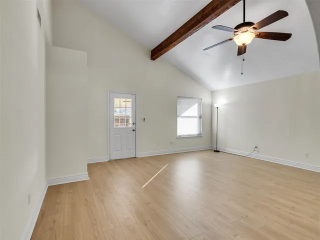 wooden floor in an empty room with a window