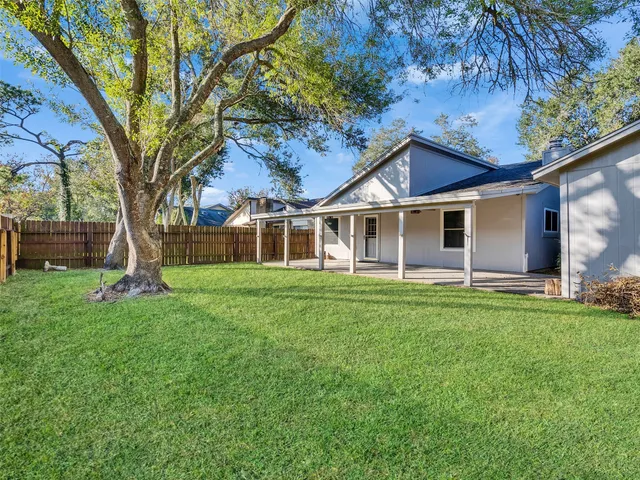 a view of a house with a backyard