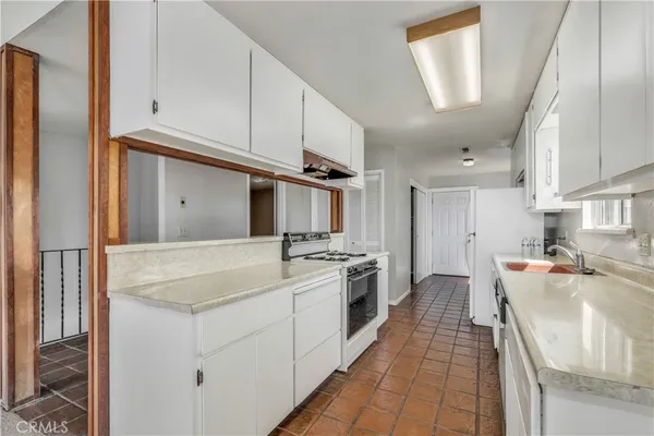 a kitchen with stainless steel appliances a sink stove and cabinets