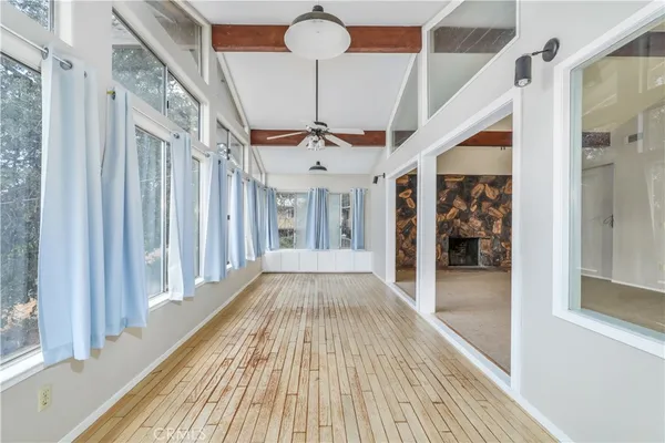 a view of a room with wooden floor and windows