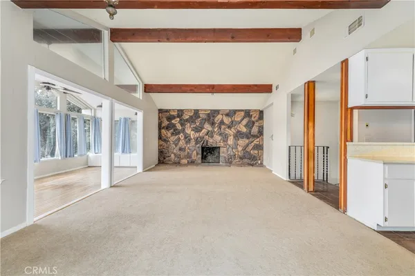 a view of a living room with furniture and a fireplace