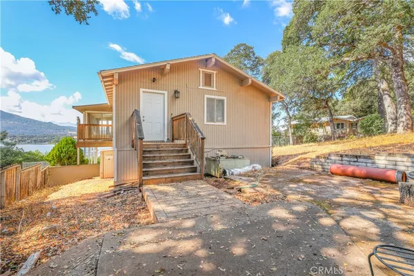 a backyard of a house with table and chairs
