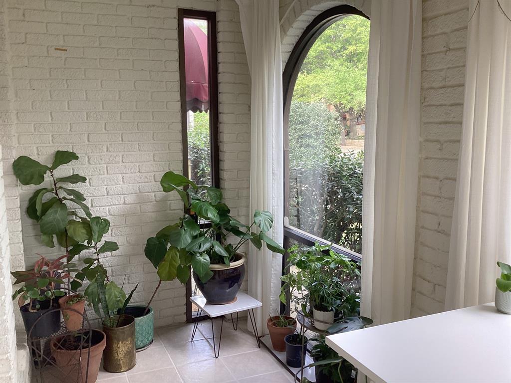 4034 Hawthorne Avenue, Unit 103 Dallas, TX 75219 - Photo 12 of 13 a vase of flowers sitting on a table in front of a window