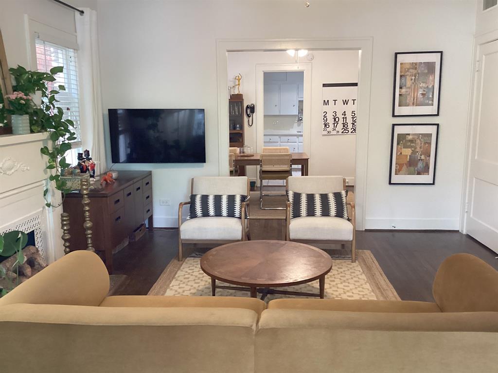 4034 Hawthorne Avenue, Unit 103 Dallas, TX 75219 - Photo 2 of 13 a living room with furniture and a flat screen tv