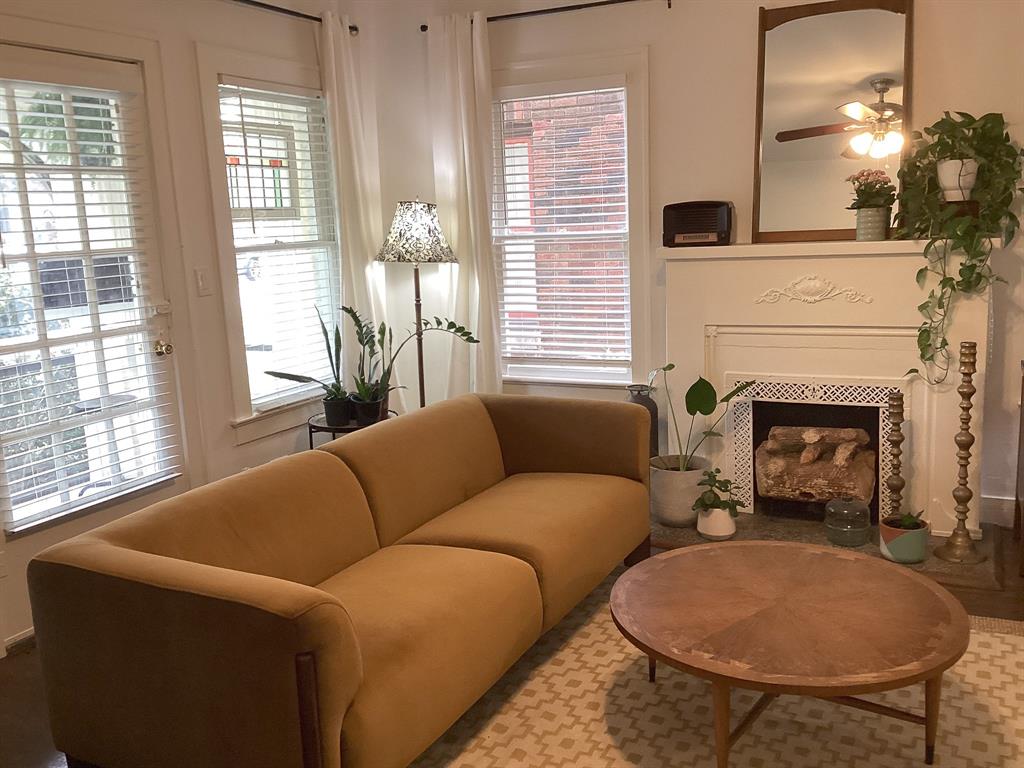 4034 Hawthorne Avenue, Unit 103 Dallas, TX 75219 - Photo 3 of 13 a living room with furniture and a fireplace