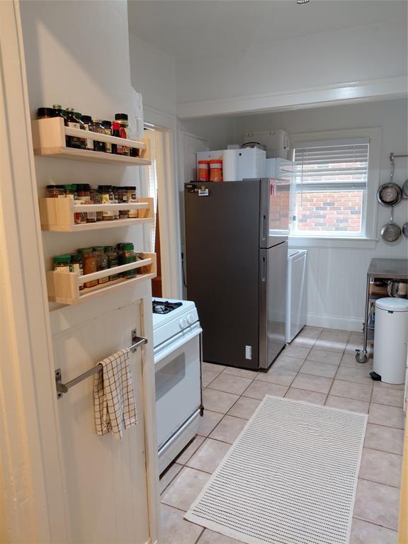 4034 Hawthorne Avenue, Unit 103 Dallas, TX 75219 - Photo 7 of 13 a kitchen with a refrigerator and window