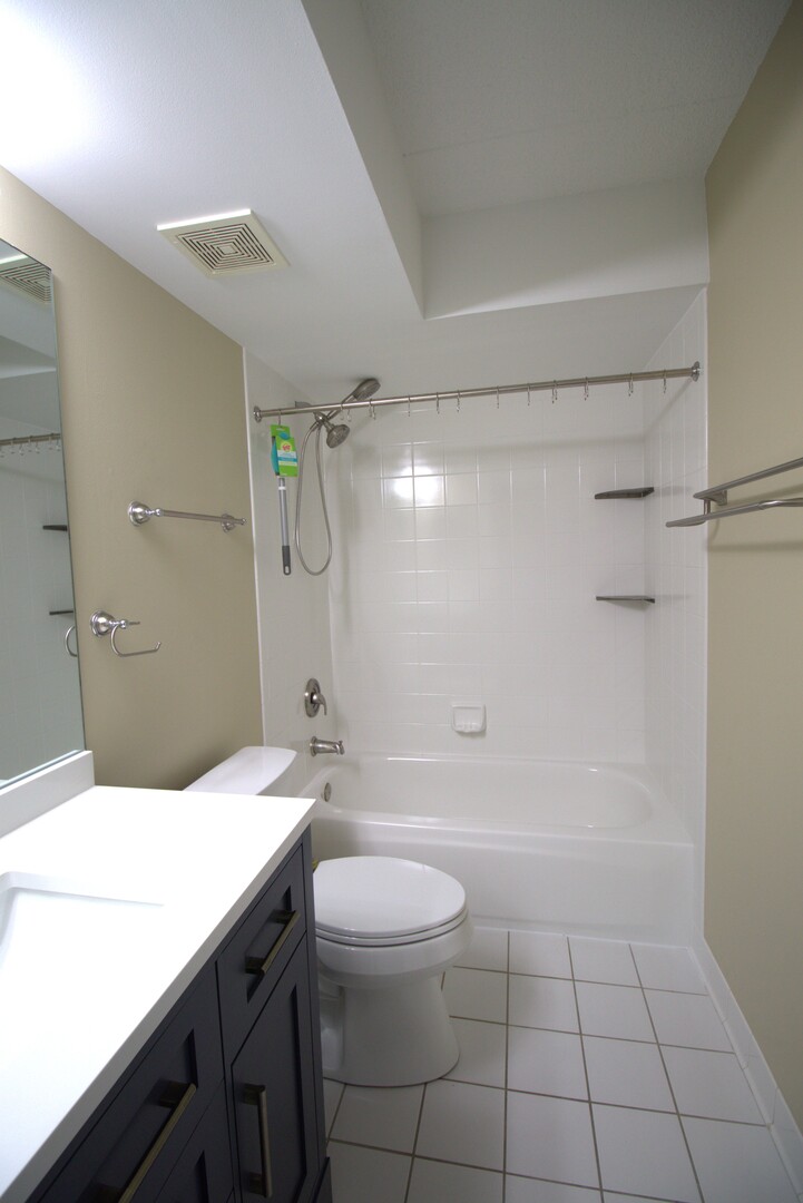 112 Day Street, Unit 204 Bloomingdale, IL 60108 - Photo 14 of 17 a bathroom with a sink a toilet and shower