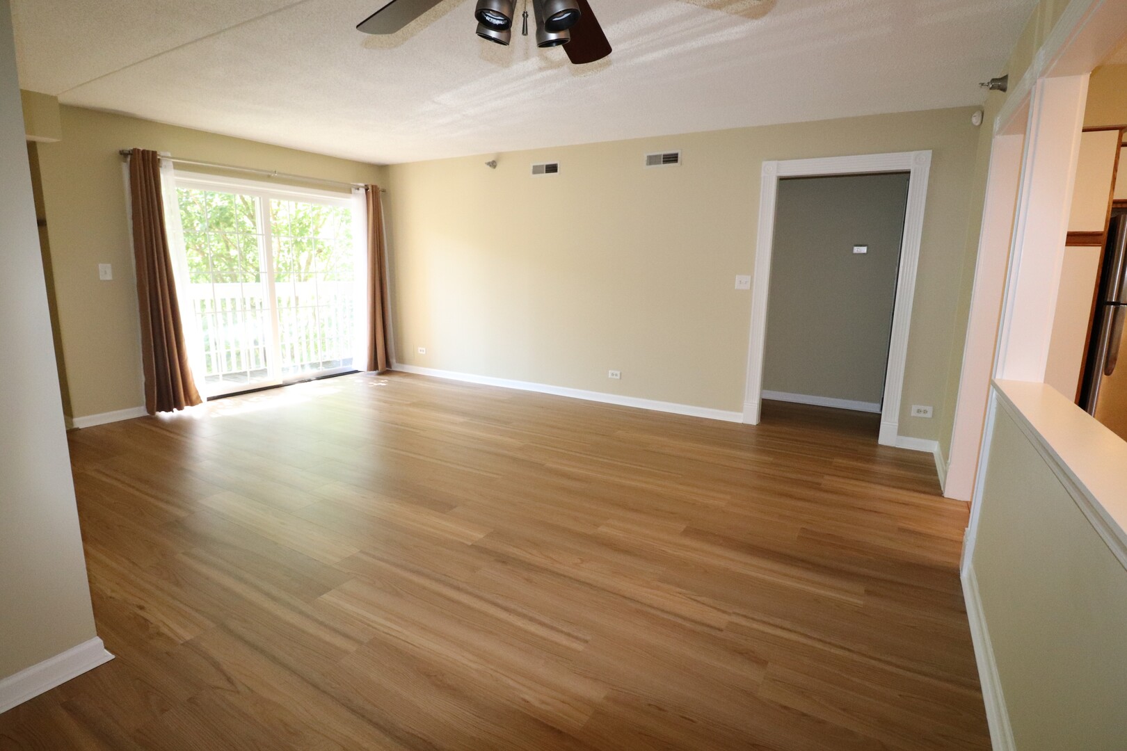 112 Day Street, Unit 204 Bloomingdale, IL 60108 - Photo 3 of 17 a view of an empty room with wooden floor and a window