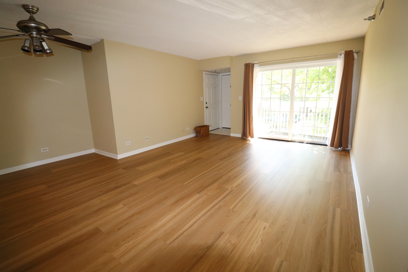 112 Day Street, Unit 204 Bloomingdale, IL 60108 - Photo 4 of 17 an empty room with wooden floor and windows