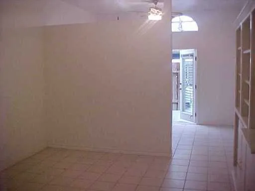 a view of an empty room and a window