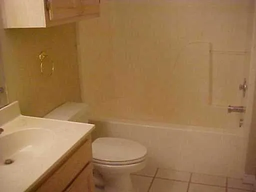 a bathroom with a sink a toilet and tub