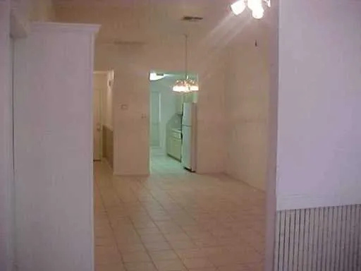 a view of a hallway with chandelier and entryway