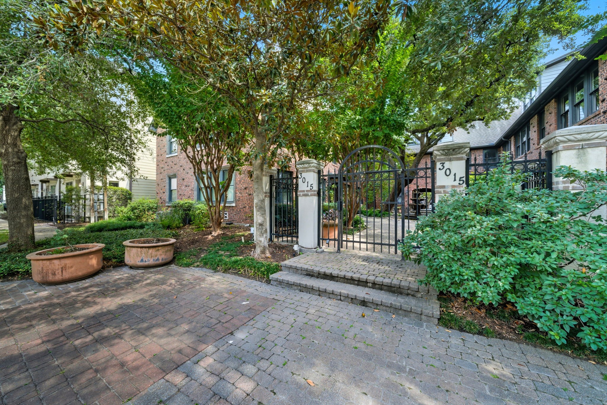 3015 Chenevert Street, Unit 1 Houston, TX 77004 - Photo 3 of 10 a view of a backyard with table and chairs potted plants and large tree