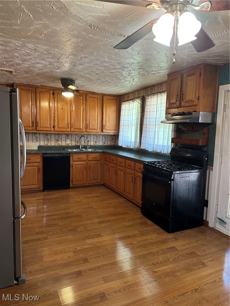 167 Andover Road Woodsfield, OH 43793 - Photo 24 of 50 Kitchen featuring Amish made Oak Cabinets, dishwashing machine, refrigerator, stove, ventilation hood, and a sink
