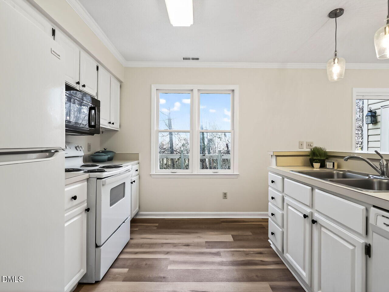 3204 Coachman's Way Durham, NC 27705 - Photo 13 of 27 a kitchen with granite countertop a sink stove and refrigerator
