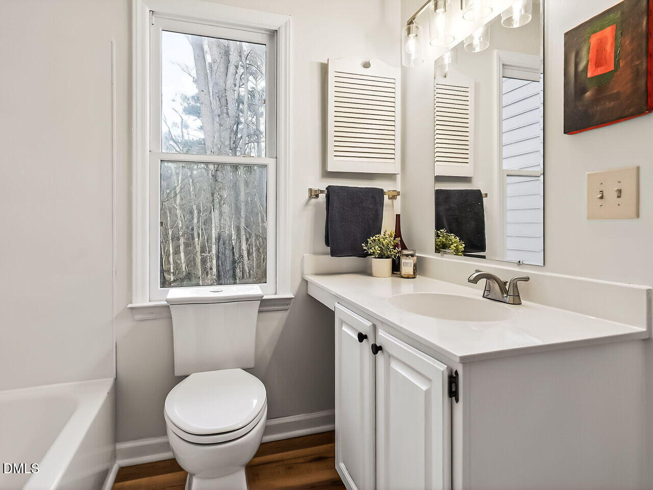 3204 Coachman's Way Durham, NC 27705 - Photo 17 of 27 a bathroom with a toilet sink and mirror