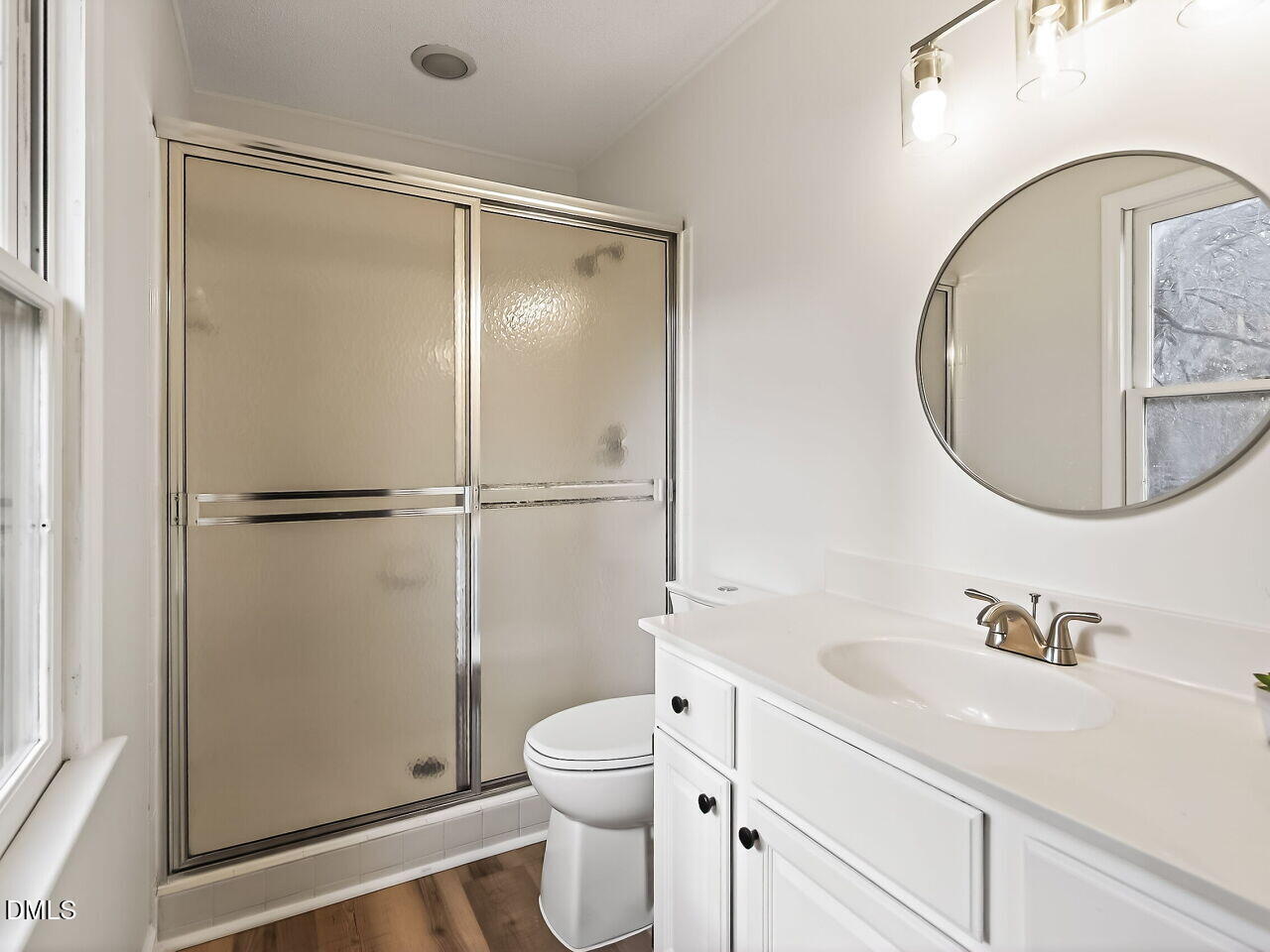 3204 Coachman's Way Durham, NC 27705 - Photo 21 of 27 a bathroom with a granite countertop sink toilet and shower