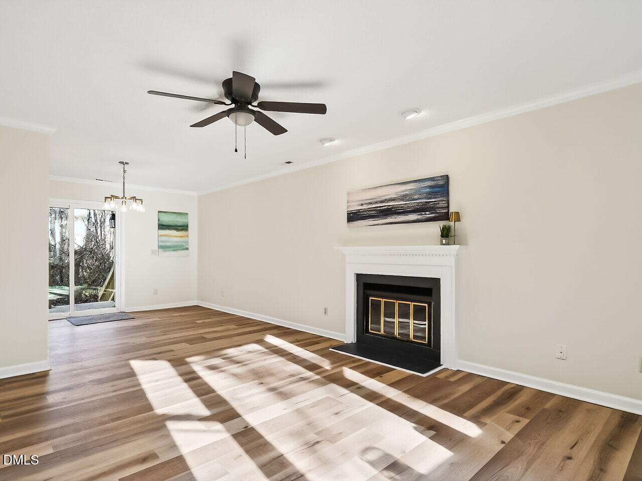 3204 Coachman's Way Durham, NC 27705 - Photo 3 of 27 a view of an empty room with wooden floor fireplace and a window