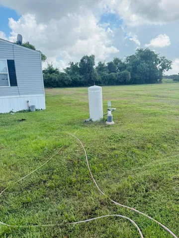 a view of a field with wooden fence