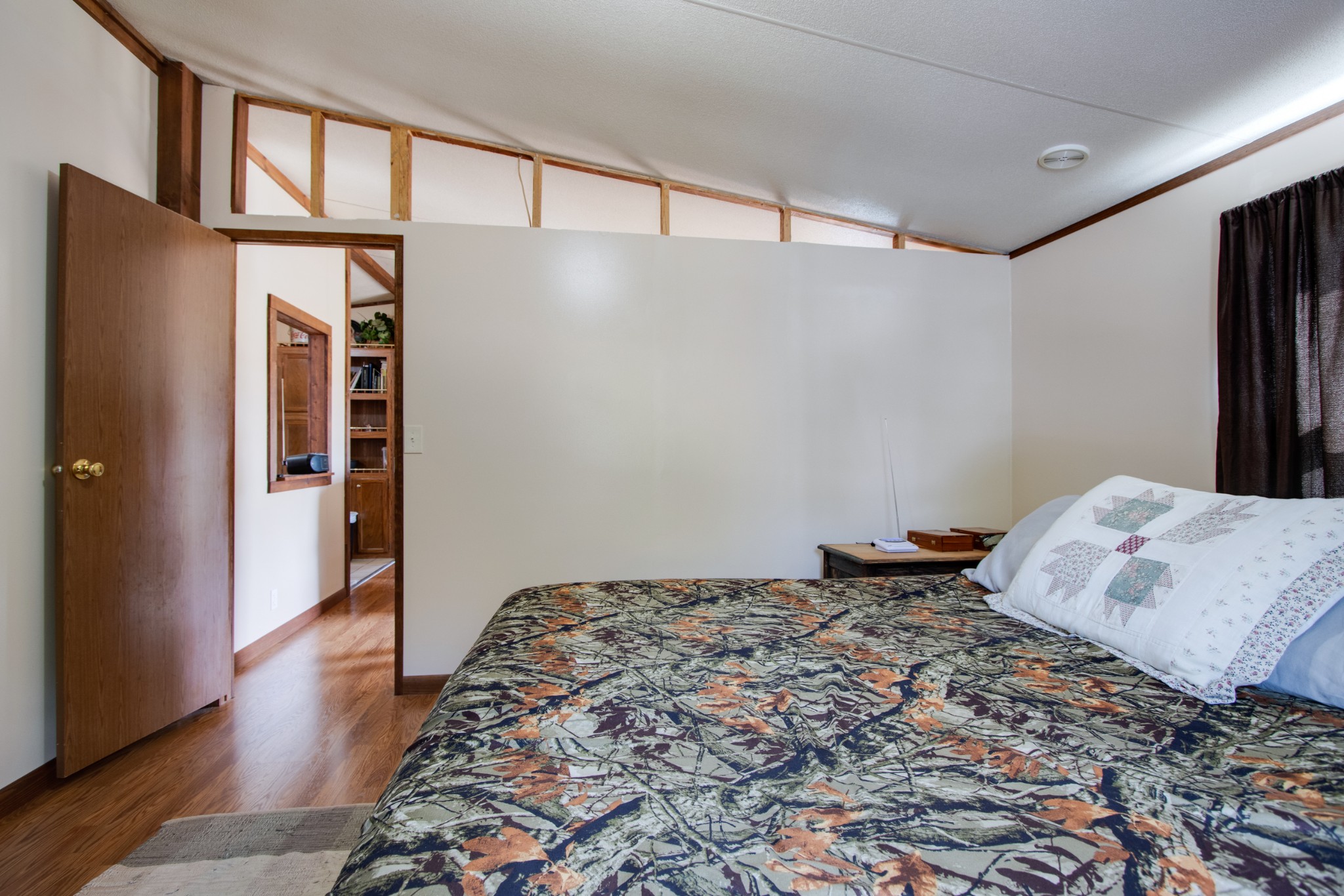 745 Holloway Road Lebanon, TN 37090 - Photo 12 of 30 a bedroom with a bed and wooden floor