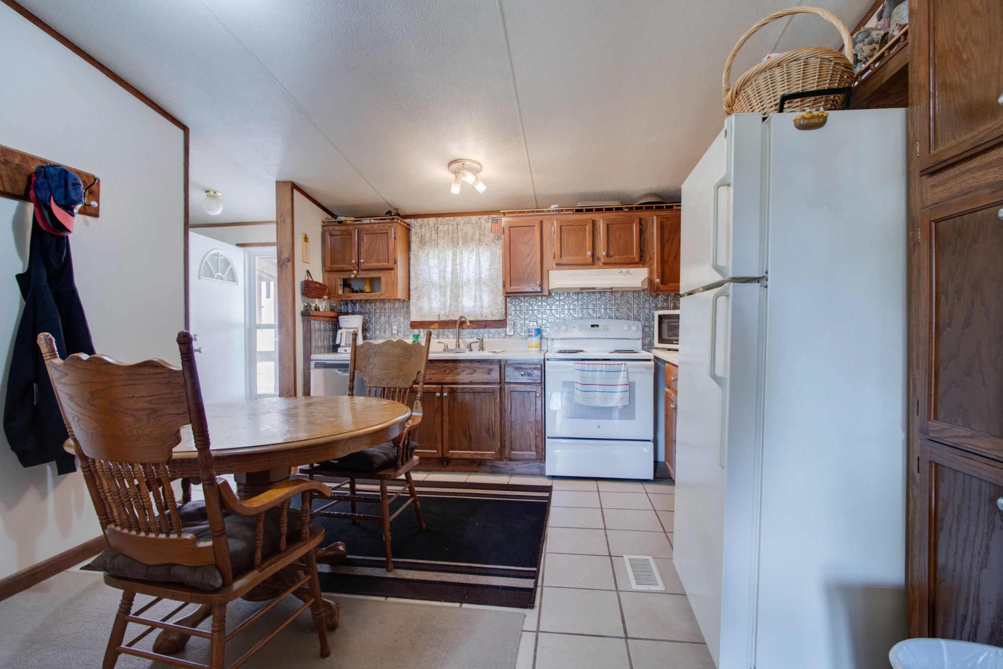 745 Holloway Road Lebanon, TN 37090 - Photo 6 of 30 a kitchen with stainless steel appliances kitchen island granite countertop a refrigerator a stove a sink dishwasher with a dining table and chairs
