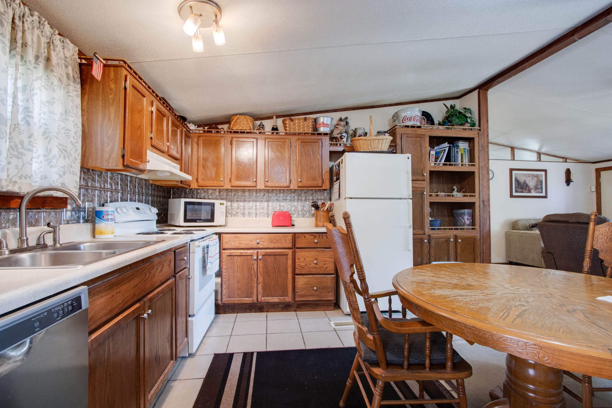 745 Holloway Road Lebanon, TN 37090 - Photo 8 of 30 a kitchen with a table chairs refrigerator and cabinets