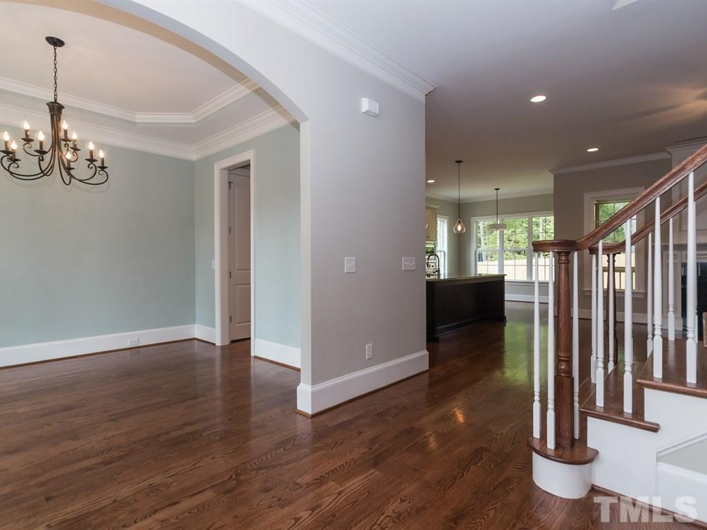 6402 Rosny Road Raleigh, NC 27613 - Photo 2 of 25 a view of a livingroom with wooden floor staircase and kitchen space