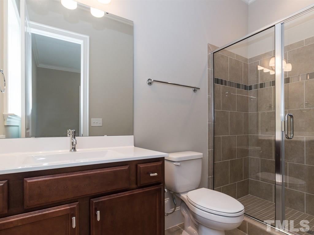 6402 Rosny Road Raleigh, NC 27613 - Photo 12 of 25 a bathroom with a sink toilet and shower