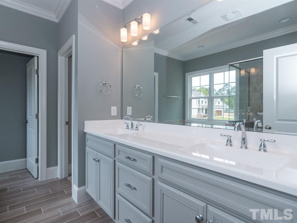 6402 Rosny Road Raleigh, NC 27613 - Photo 16 of 25 a bathroom with a sink double vanity and a mirror