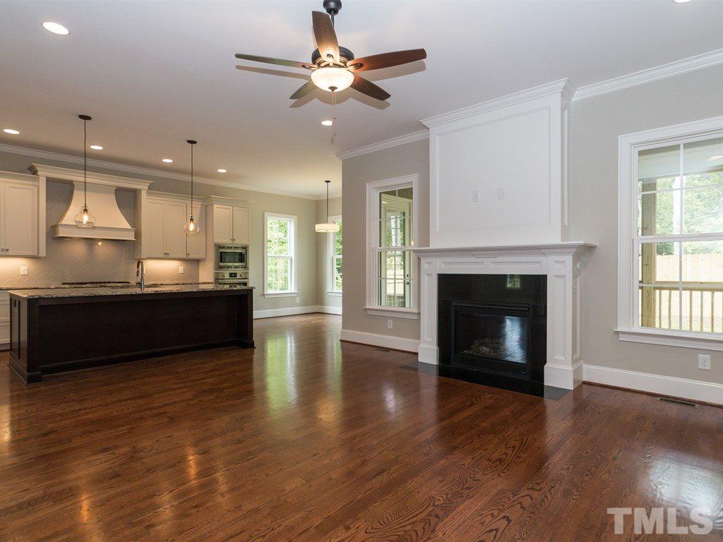 6402 Rosny Road Raleigh, NC 27613 - Photo 6 of 25 a view of a kitchen with a sink and a fireplace