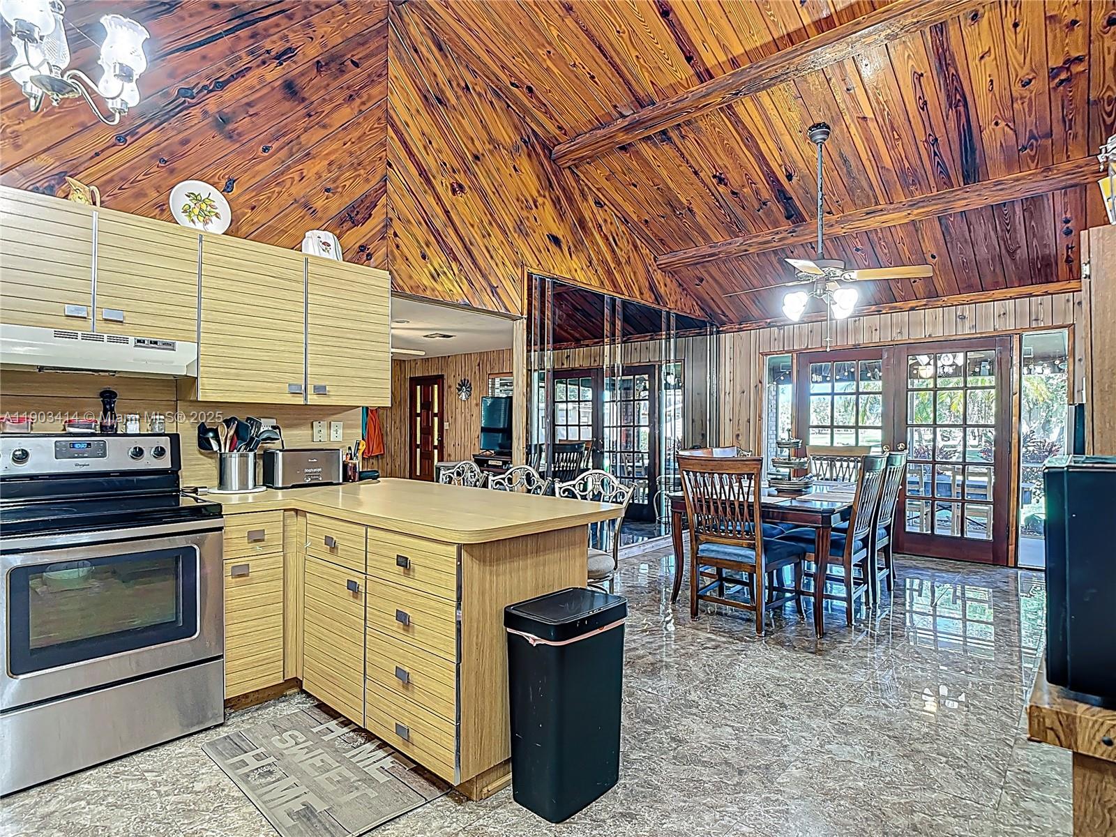 4419 Loblolly Bay Road Southwest LaBelle, FL 33935 - Photo 14 of 49 a dining hall with stainless steel appliances granite countertop a stove a sink and a refrigerator