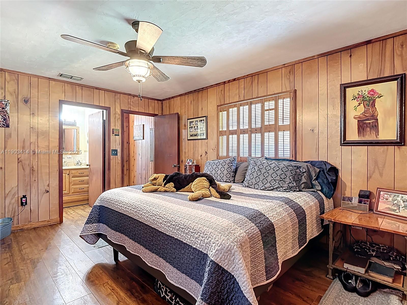 4419 Loblolly Bay Road Southwest LaBelle, FL 33935 - Photo 19 of 49 a bedroom with a bed and a chandelier