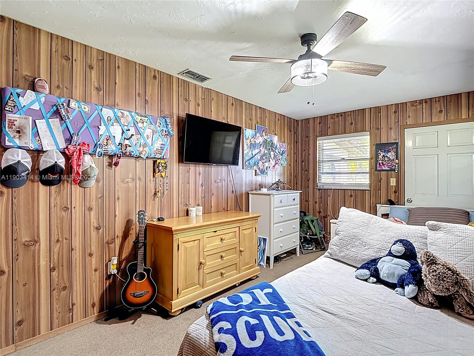 4419 Loblolly Bay Road Southwest LaBelle, FL 33935 - Photo 21 of 49 a bedroom with furniture and a flat screen tv