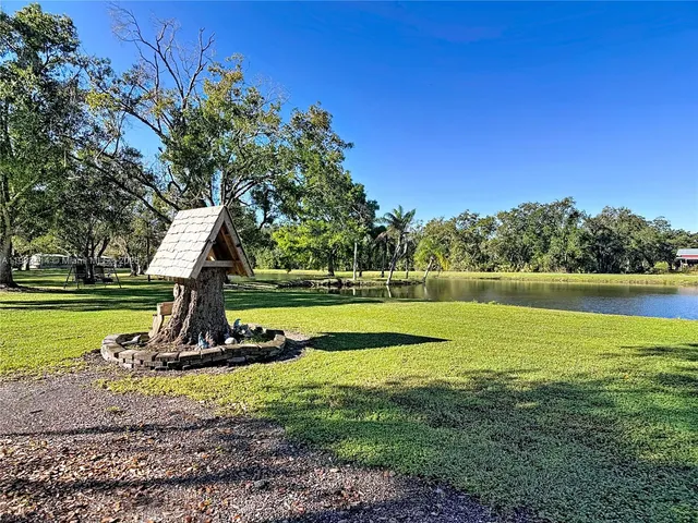 a view of a house with backyard and sitting area