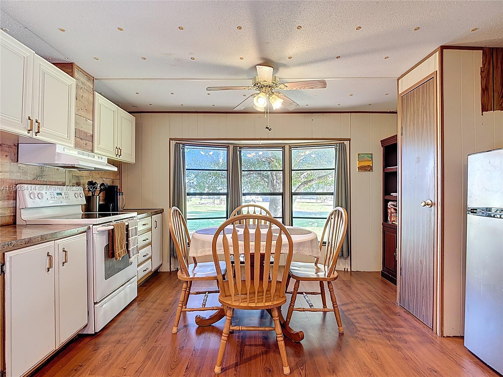 4419 Loblolly Bay Road Southwest LaBelle, FL 33935 - Photo 34 of 49 a view of a dining room with furniture window and wooden floor