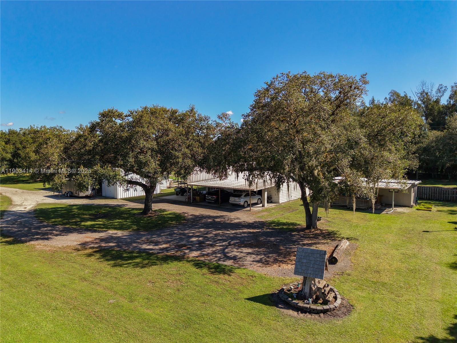 4419 Loblolly Bay Road Southwest LaBelle, FL 33935 - Photo 4 of 49 a swimming pool with trees in the background