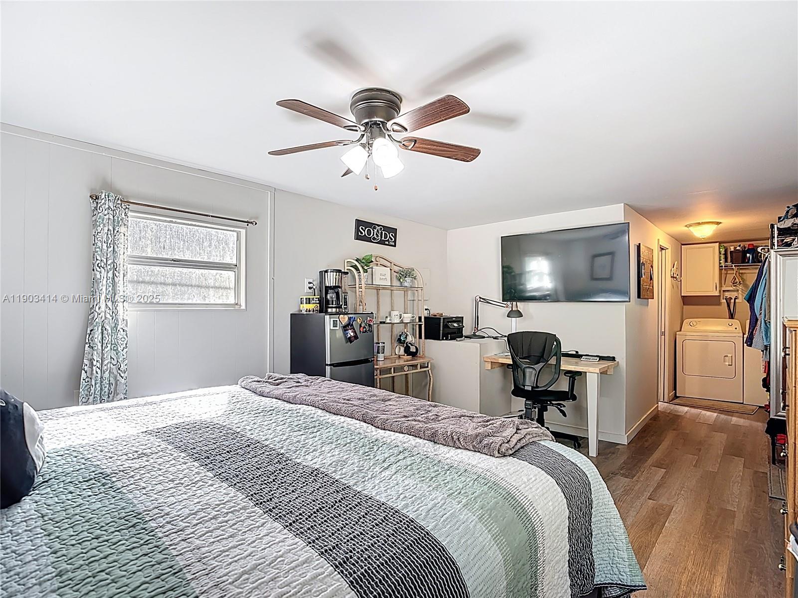 4419 Loblolly Bay Road Southwest LaBelle, FL 33935 - Photo 44 of 49 a bedroom with a bed and a chandelier