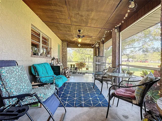 a work room with furniture and large windows