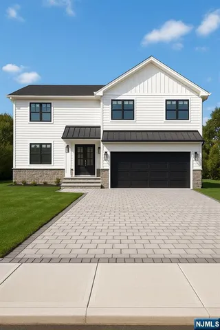 a front view of a house with a garden and yard