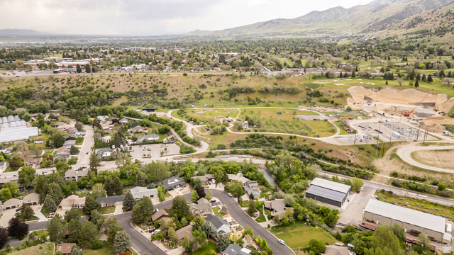1552 Sumac Drive Logan, UT 84321 - Photo 61 of 72 Aerial perspective showcasing a residential neighborhood with established homes, tree-lined streets, and surrounding green spaces